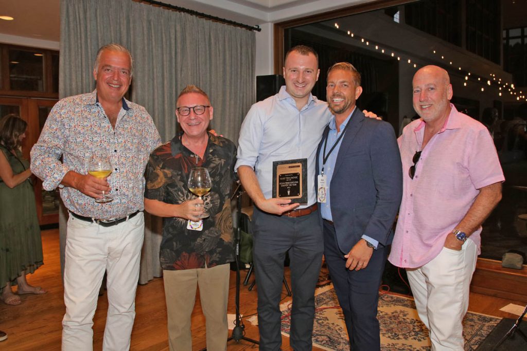 Group of people standing with award winner.