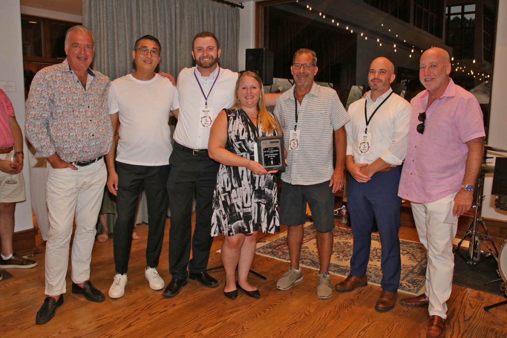 Group of people standing with award winner