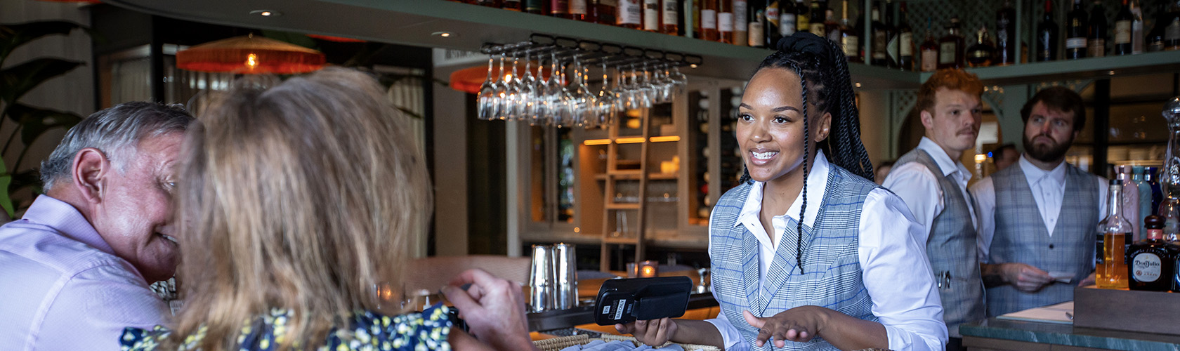 Bar chef talking with guests at Del Mar Mediterranean - a Cameron Mitchell Restaurant.